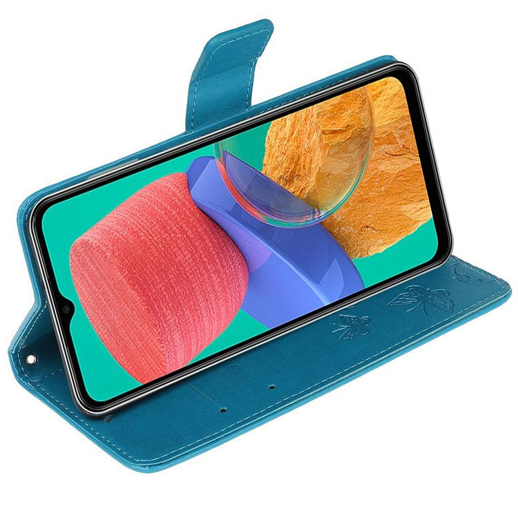 For Samsung Galaxy M33 5G (India Version) PU Leather Magnetic Flip Cover Butterfly Flower Imprinted Stand Hand Strap Wallet Purse Case - Blue