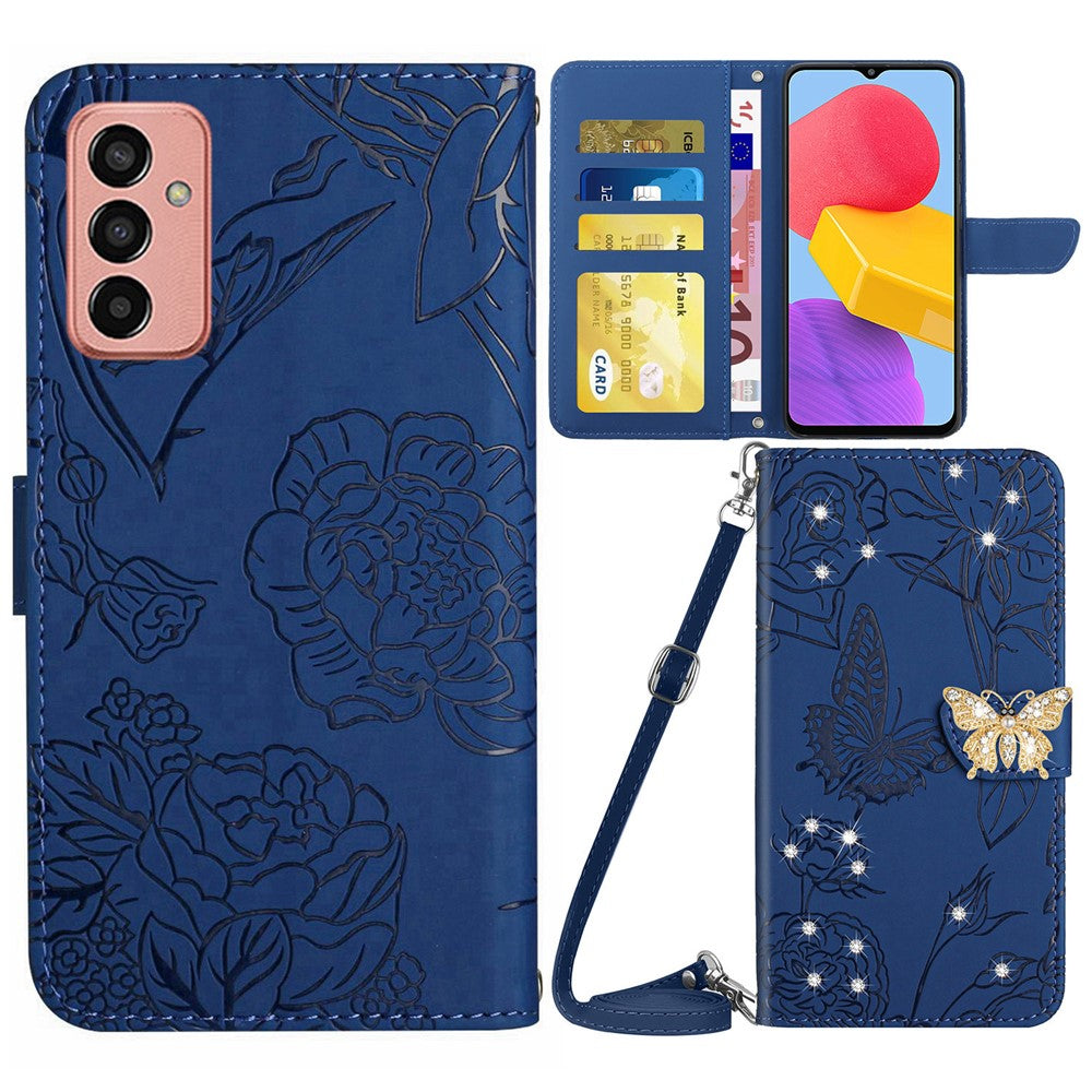 For Samsung Galaxy M13 4G Butterfly Flowers Imprinted Rhinestone Decor Phone Cover Wallet Stand Well-protected Leather Case with Shoulder Strap - Blue