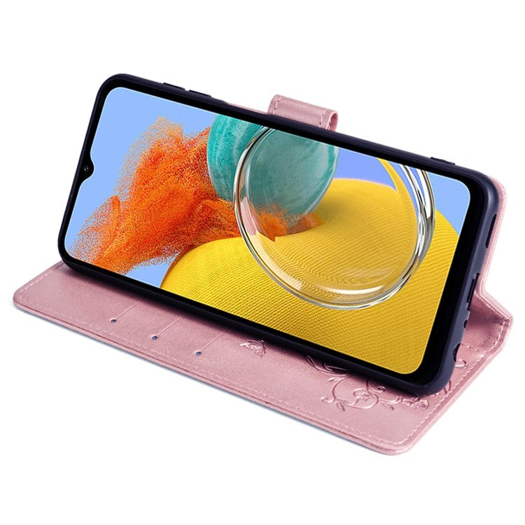 For Samsung Galaxy M14 5G Phone Case Butterfly Flower Imprinted Leather Flip Cover with Wrist Strap - Rose Gold