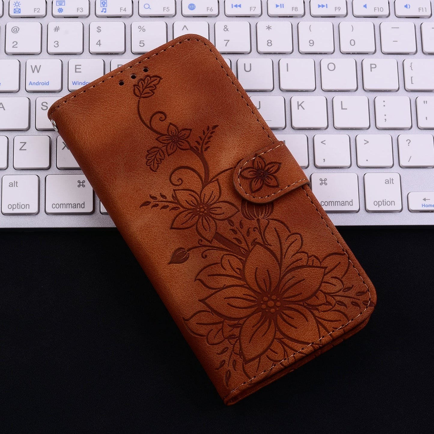 For iPhone 16e Lily Embossed Leather Phone Case(Brown)