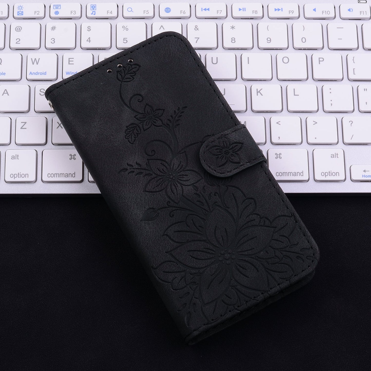 For iPhone 16e Lily Embossed Leather Phone Case(Black)