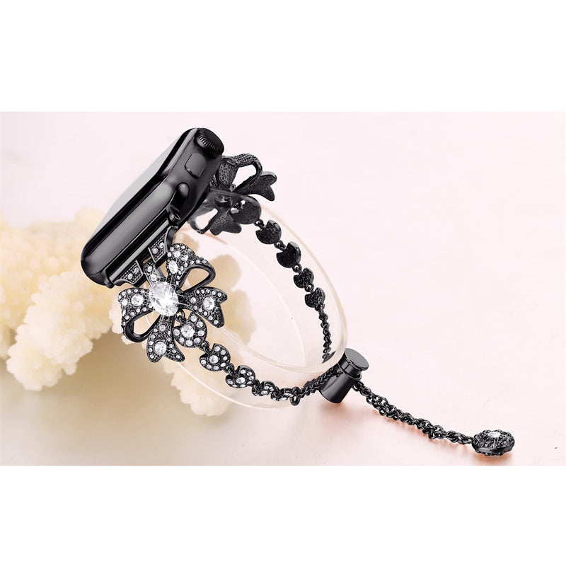 for Apple Watch Series 8 / 7 41mm / 6 / 5 / 4 / SE / SE (2022) 40mm / 3 / 2 / 1 38mm Rhinestones Decor Bowknot Bracelet Metal Watch Strap Adjustable Wrist Band - Black