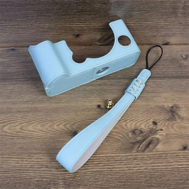 Uniqkart for Fujifilm X-T5 Camera PU Leather Protective Case Battery Opening Design Half Body Cover with Hand Strap - Baby Blue