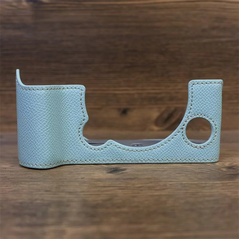 Uniqkart for Fujifilm X-T5 Camera PU Leather Protective Case Battery Opening Design Half Body Cover with Hand Strap - Baby Blue