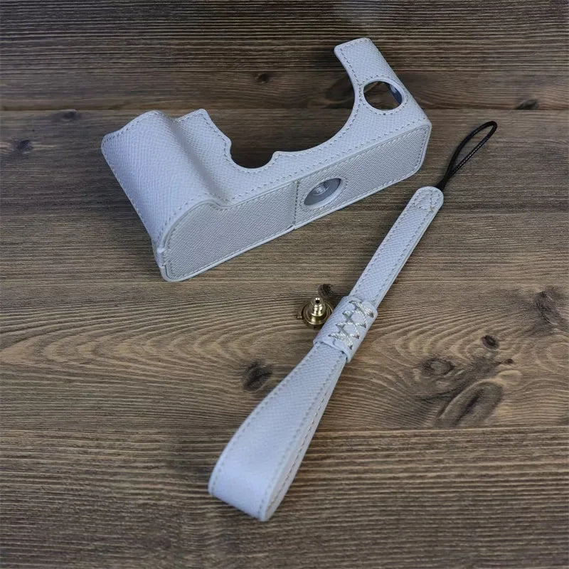 Uniqkart for Fujifilm X-T5 Camera PU Leather Protective Case Battery Opening Design Half Body Cover with Hand Strap - White