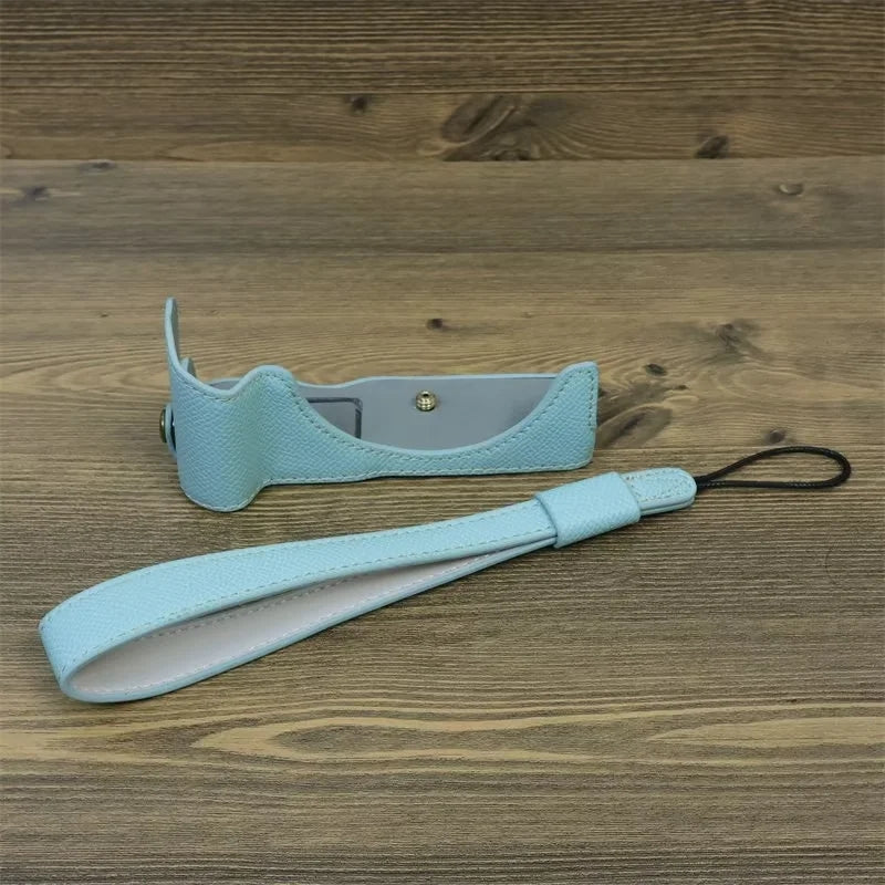 Uniqkart for Canon EOS R50 Anti-Shock PU Leather Camera Bottom Cover Large Opening Design Half Body Case with Strap - Baby Blue