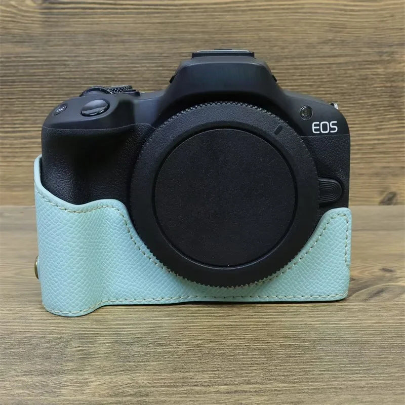 Uniqkart for Canon EOS R50 Anti-Shock PU Leather Camera Bottom Cover Large Opening Design Half Body Case with Strap - Baby Blue