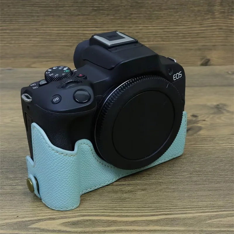 Uniqkart for Canon EOS R50 Anti-Shock PU Leather Camera Bottom Cover Large Opening Design Half Body Case with Strap - Baby Blue