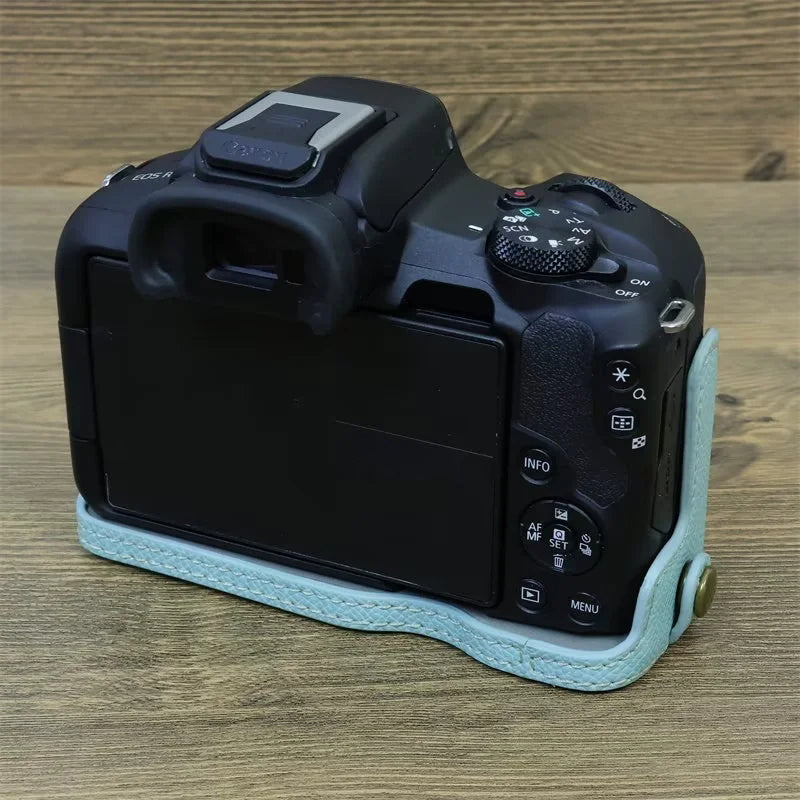 Uniqkart for Canon EOS R50 Anti-Shock PU Leather Camera Bottom Cover Large Opening Design Half Body Case with Strap - Baby Blue
