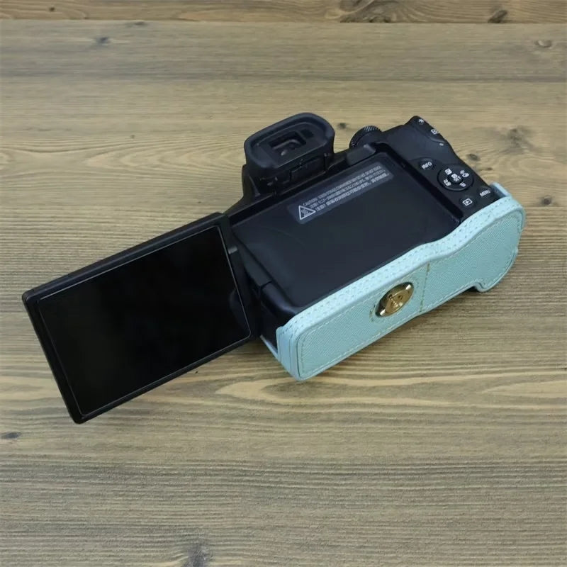 Uniqkart for Canon EOS R50 Anti-Shock PU Leather Camera Bottom Cover Large Opening Design Half Body Case with Strap - Baby Blue