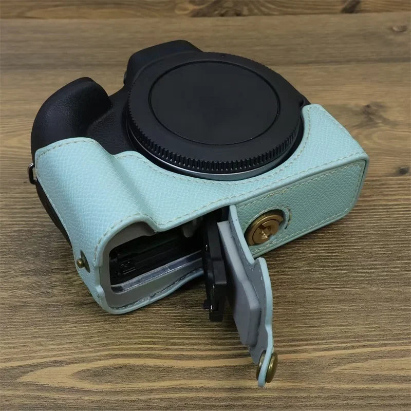 Uniqkart for Canon EOS R50 Anti-Shock PU Leather Camera Bottom Cover Large Opening Design Half Body Case with Strap - Baby Blue