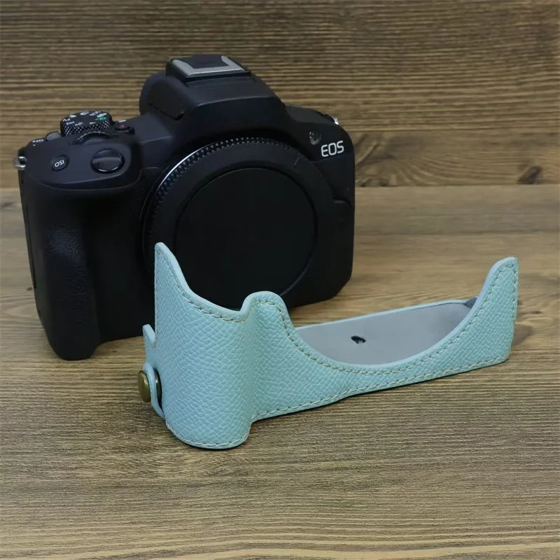 Uniqkart for Canon EOS R50 Anti-Shock PU Leather Camera Bottom Cover Large Opening Design Half Body Case with Strap - Baby Blue
