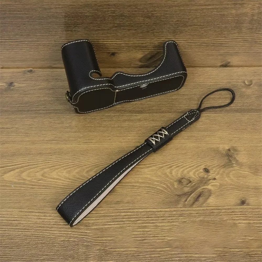 Uniqkart for Sony ZV-E1 Battery Opening Design PU Leather Camera Bottom Cover Half Body Case with Hand Strap - Black