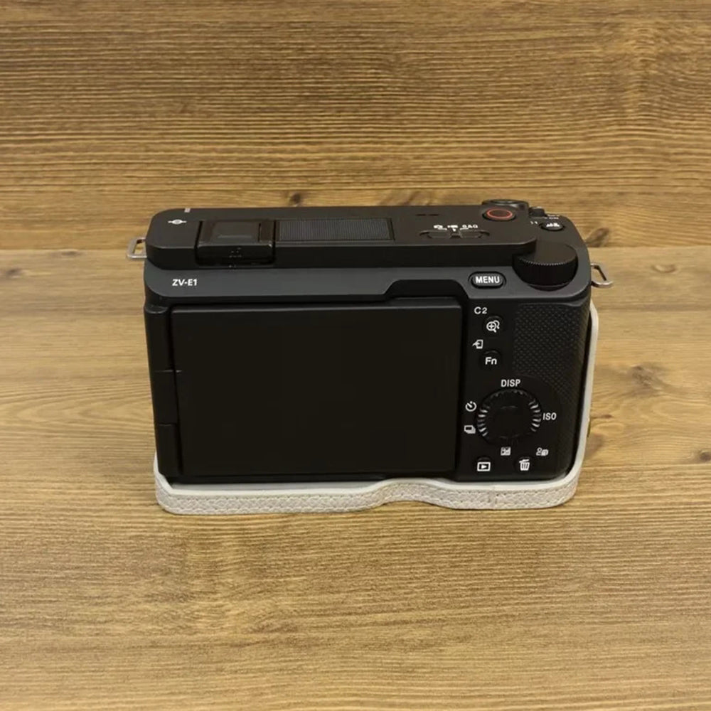 Uniqkart for Sony ZV-E1 Battery Opening Design PU Leather Camera Bottom Cover Half Body Case with Hand Strap - Grey White