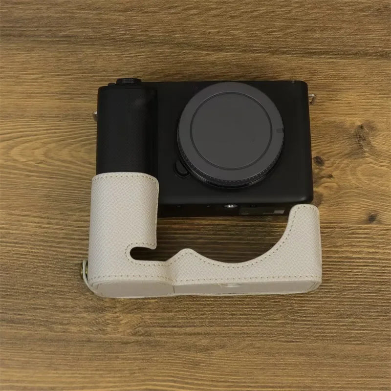 Uniqkart for Sony ZV-E1 Battery Opening Design PU Leather Camera Bottom Cover Half Body Case with Hand Strap - Grey White