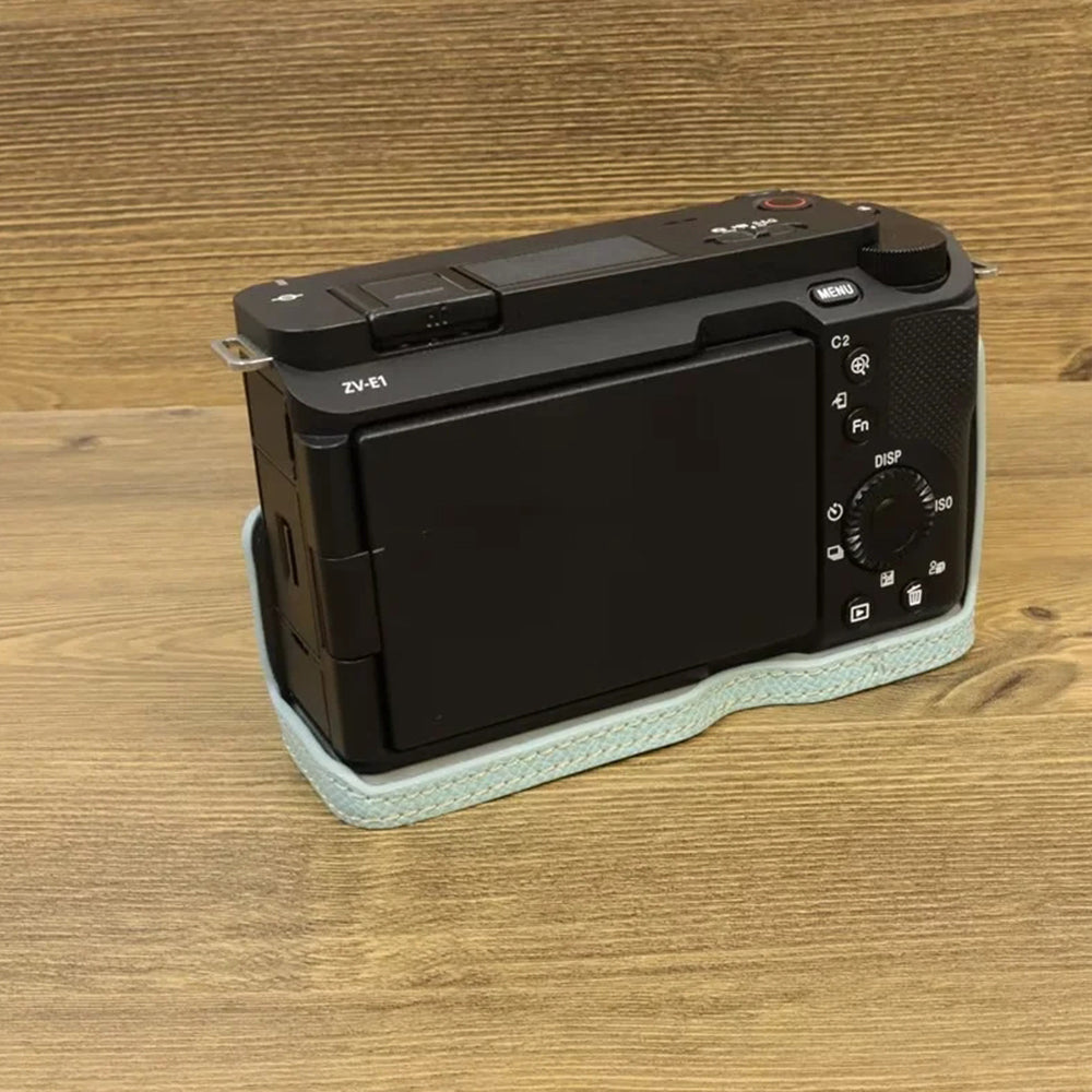 Uniqkart for Sony ZV-E1 Battery Opening Design PU Leather Camera Bottom Cover Half Body Case with Hand Strap - Baby Blue