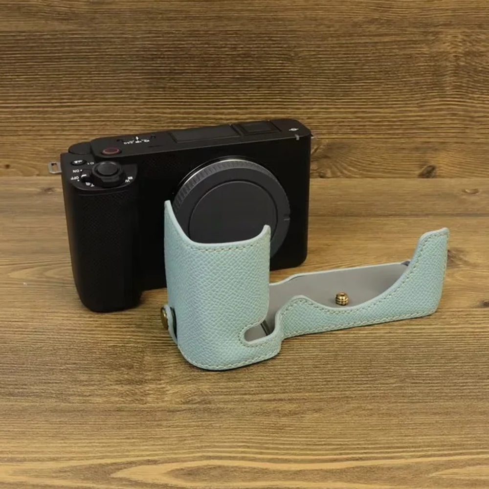 Uniqkart for Sony ZV-E1 Battery Opening Design PU Leather Camera Bottom Cover Half Body Case with Hand Strap - Baby Blue