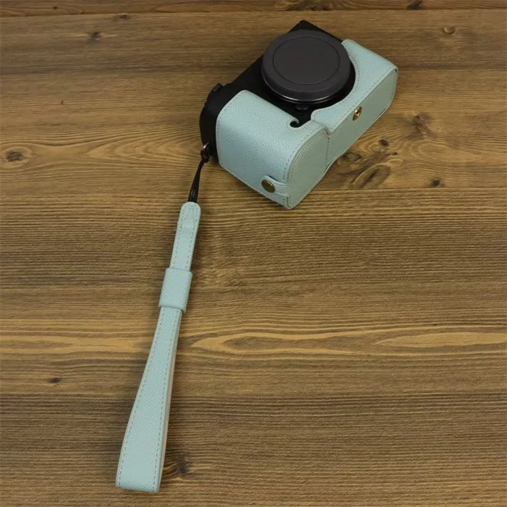 Uniqkart for Sony ZV-E1 Battery Opening Design PU Leather Camera Bottom Cover Half Body Case with Hand Strap - Baby Blue