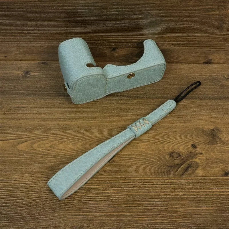 Uniqkart for Sony ZV-E1 Battery Opening Design PU Leather Camera Bottom Cover Half Body Case with Hand Strap - Baby Blue