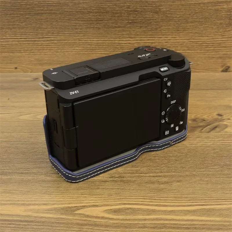 Uniqkart for Sony ZV-E1 Battery Opening Design PU Leather Camera Bottom Cover Half Body Case with Hand Strap - Dark Blue