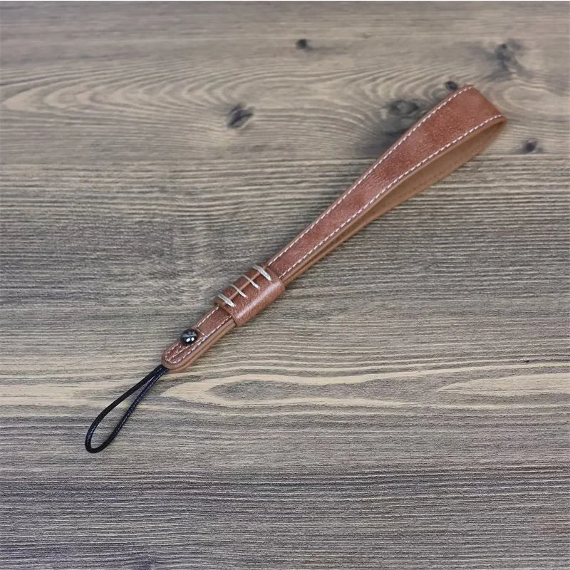 Uniqkart for Fuji / Canon / Nikon / Panasonic DSLR Camera 2mm Connector PU Leather Wrist Strap Hand Grip Rope - Brown