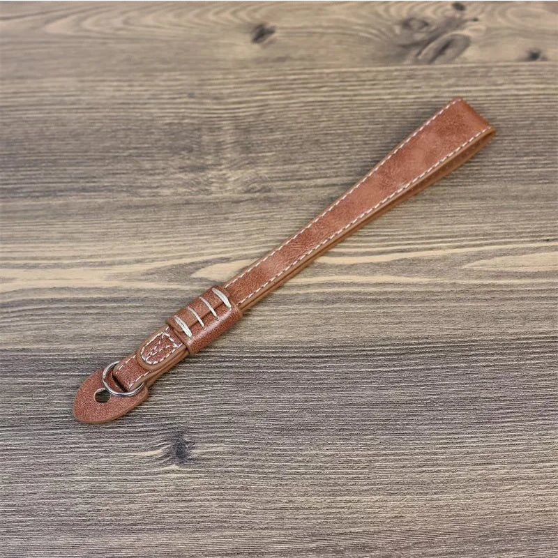 Uniqkart for Fujifilm xt5 / xh2 / xt4 / xs10 / xt30II Camera PU Leather Hand Strap SLR Camera Anti-lost Wrist Rope - Brown