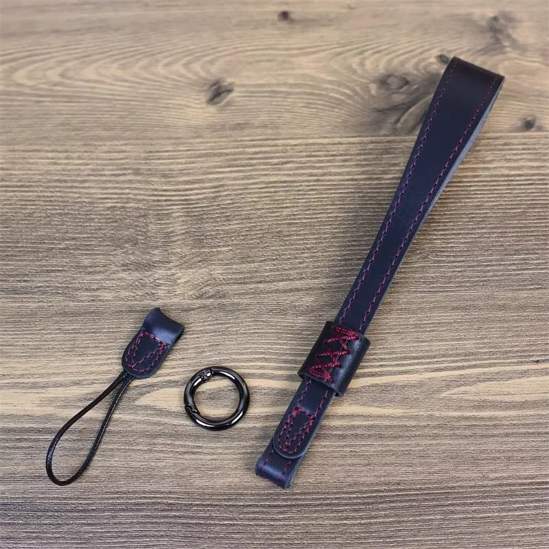 Uniqkart for Fujifilm XT4 / A7r5 / A7M4 / X100v / XH2 Camera Carrying Strap Top Layer Cowhide Leather Quick Release Hand Rope - Black