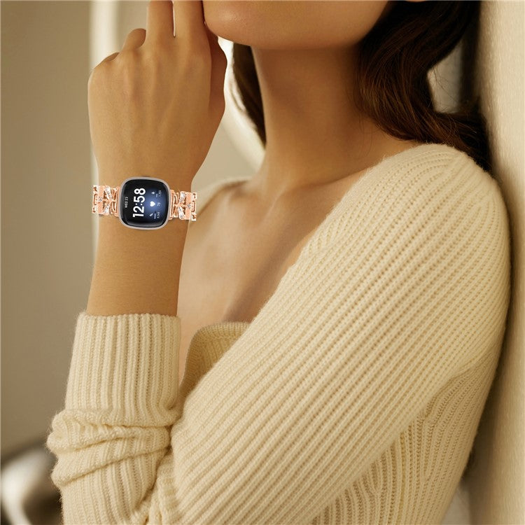 For Fitbit Versa 4 / Sense 2 Zinc Alloy Strap Rhinestones Decor Crown X-shape Smartwatch Band - Rose Gold