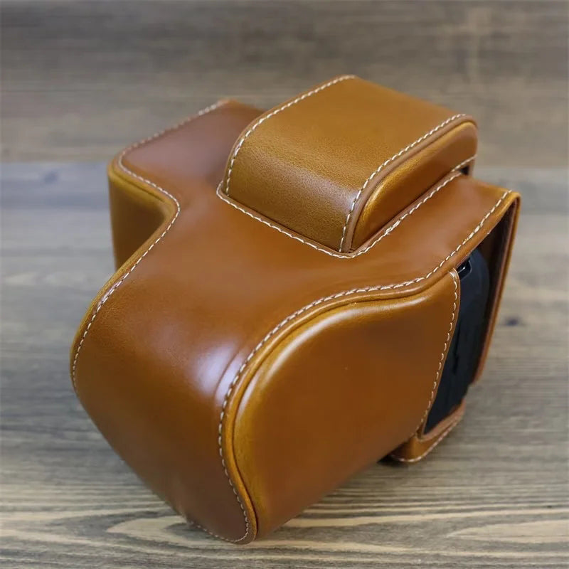 PU Leather Camera Case Bag for Canon EOS R10, Battery Opening Design Protective Cover with Lens Pouch and Strap - Brown